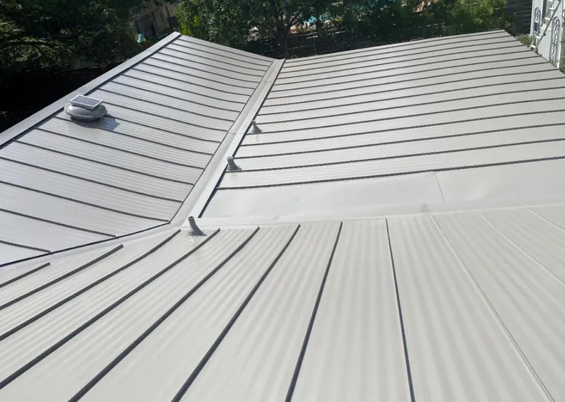 Solar attic fan installed on a metal roof for Roof Ventilation in Severance